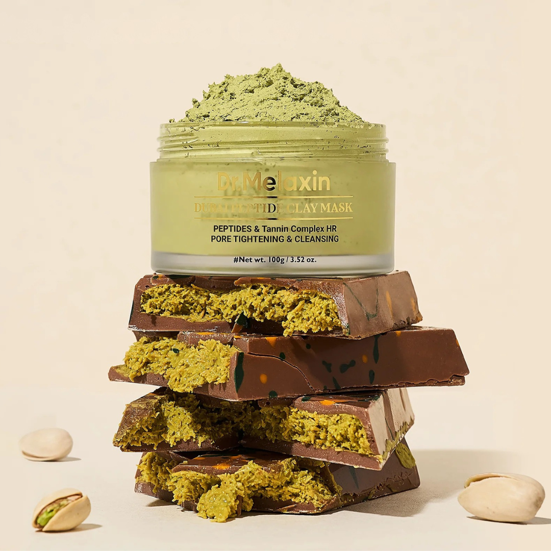 Dr. Melaxin Dubai Peptide Clay Mask 100g - lifestyle shot with chocolate and pistachios