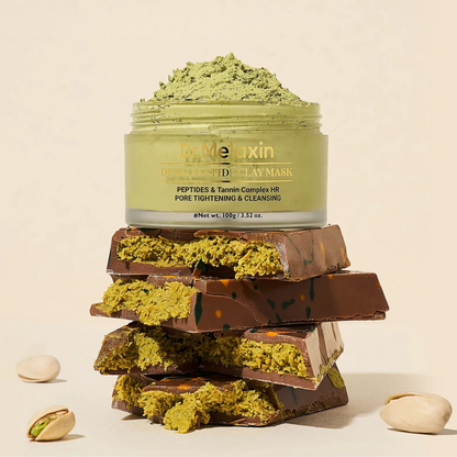 Dr. Melaxin Dubai Peptide Clay Mask 100g - lifestyle shot with chocolate and pistachios